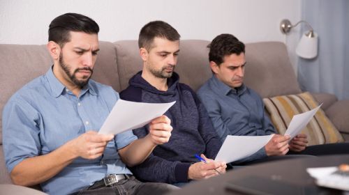 co-executors of an estate reading over paperwork.