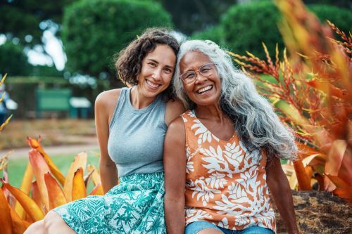 two women smiling outside