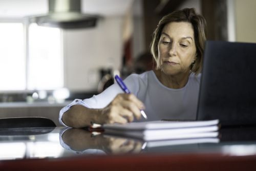 an older woman writing out her will