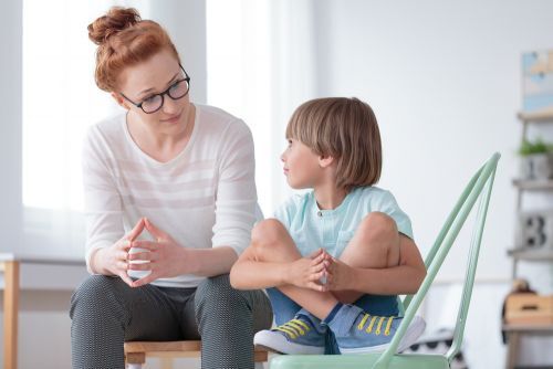 a woman having a discussion with a child