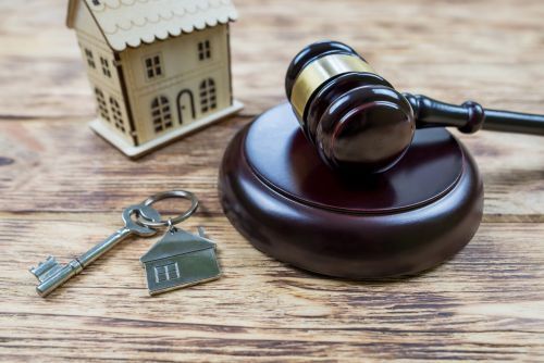 a small house with a gavel and house keys